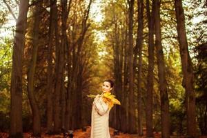 girl walking in the park in autumn photo