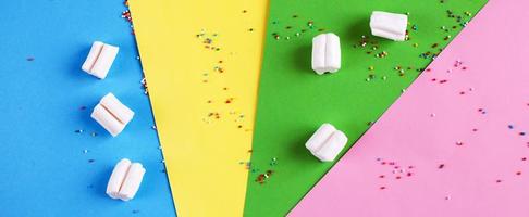Colored marshmallow composition on on colorful background. Flat lay, holiday concept. banner photo