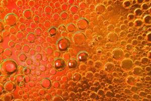 abstract light orange background with oil circles . oil bubbles of water close up. fiery circle bubbles background photo