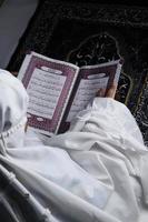 little girl reading the Quran. Islamic concept photo