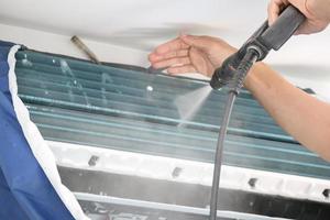 air conditioning cleaning service with water spray photo