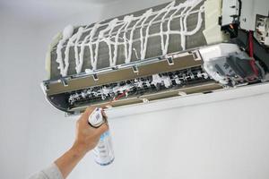 air conditioner cleaning with spray foam cleaner photo