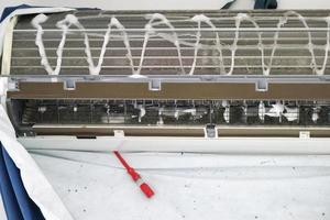 air conditioner cleaning with spray foam cleaner photo