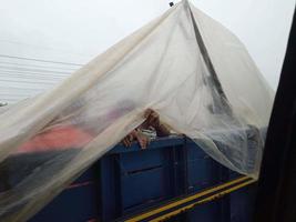 People getting into truck back to go to their home districts on a busy road Eid journy of poor people in bangladesh who are travelling in the rainy time in bangladesh during the eid season photo