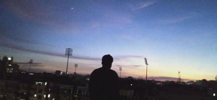 man standing in front of mirpur stadium bangladesh dhaka area sunset photo