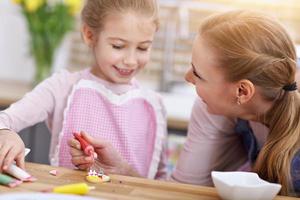 Mother and daughter preparing cookies in the kitchen photo