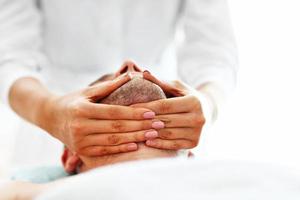 Handsome man having massage in spa salon photo