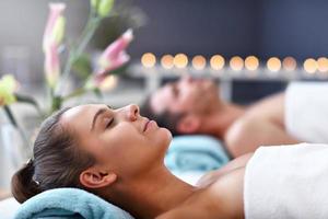 Adult happy couple relaxing in spa salon photo