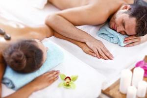 Adult happy couple relaxing in spa salon photo