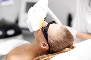 Beautician Giving Epilation Laser Treatment To Woman On Face photo