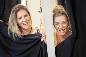 Happy woman shopping for clothes in store photo