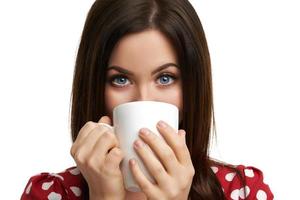 Caucasian brunette woman with mug of coffee isolated over white background photo