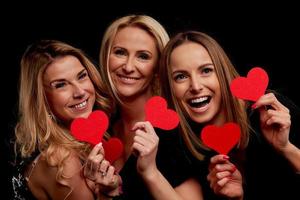 Group of friends partying and holding hearts photo