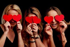 Group of friends partying and holding hearts photo