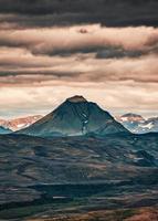 Volcano mountain on lava field and cloudy sky in Icelandic Highlands photo