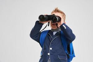 Portrait of a boy ready to school isolated on white photo