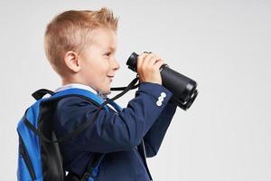 Portrait of a boy ready to school isolated on white photo