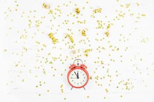 New Year composition alarm clock golden confetti photo