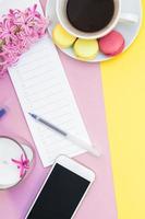 Creative flat lay with coffee cup and macaroons photo