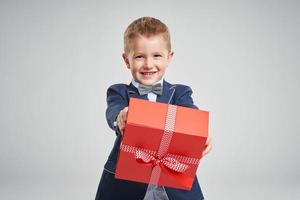 Portrait of happy cute little kid holding gift photo