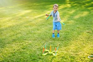 Happy 3 year old boy having fun playing outside photo