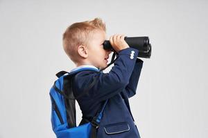 Portrait of a boy ready to school isolated on white photo