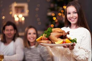 Beautiful family eating Christmas dinner at home photo