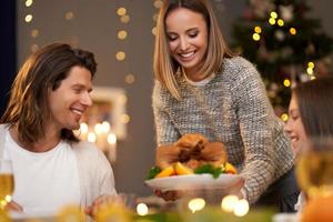 Beautiful family eating Christmas dinner at home photo