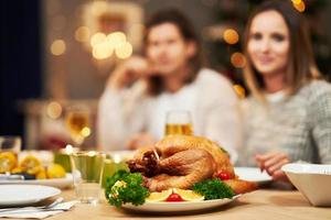 Beautiful family eating Christmas dinner at home photo