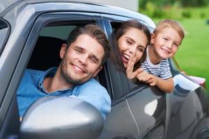 Family sitting in the car looking out windows photo