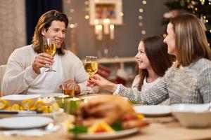 Beautiful family eating Christmas dinner at home photo