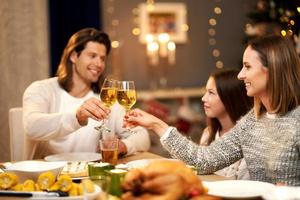 Beautiful family eating Christmas dinner at home photo