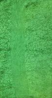 Green terry towel background. Texture of terry cloth photo