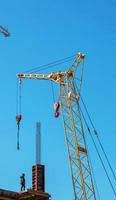 A worker prepares formwork for a modern metal-concrete structure of a residential building. photo