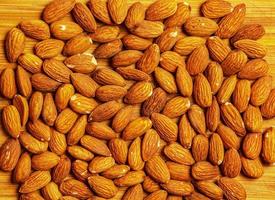 Pattern Organic almond nut raw peeled as background, top view. Healthy snack or for vegetarians. photo