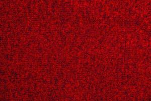 Red knitted wool Christmas background. Warm sweater atmosphere. Christmas wallpaper. Texture of woolen or acrylic jersey. Basis for winter design photo