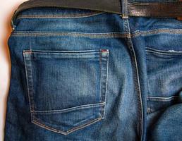 Textured old blue worn jeans - trendy jeans design. Details. photo