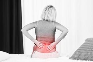 Adult woman feeling unewll suffering from backache pain photo