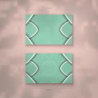 A mint colored business card with vintage white ornaments for your personality. vector