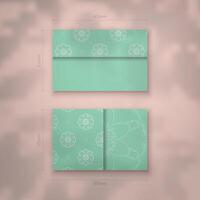 Mint color business card with Greek white pattern for your contacts. vector