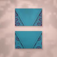 Presentable business card in turquoise color with Indian purple pattern for your brand. vector