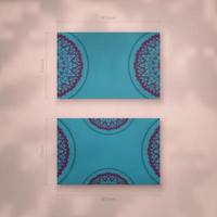 Presentable business card in turquoise color with Indian purple pattern for your business. vector