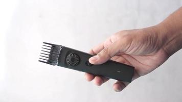 Electric hair clippers with guard held in hand video