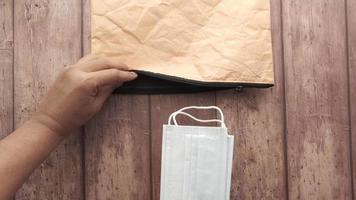 Packing face masks and sanitizer into brown bag video