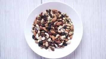 Bowl of mixed nuts and dried fruit at table video