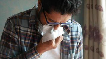 Man blows nose into tissue video
