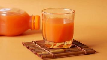 Orange juice in glass on table video