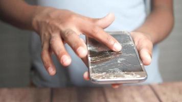 Smashed screen of smartphone, man touches it video