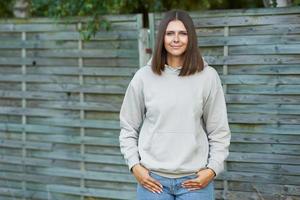 Young woman in beige hoodie. photo