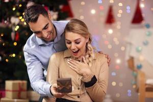 Happy Couple Opening Christmas Present photo